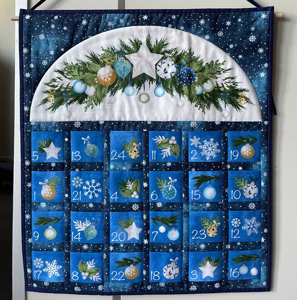 Quilted Advent calendar made with pre-printed fabric.