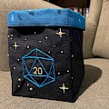 Dice bag embroidered with an outline of a d20 and stars.