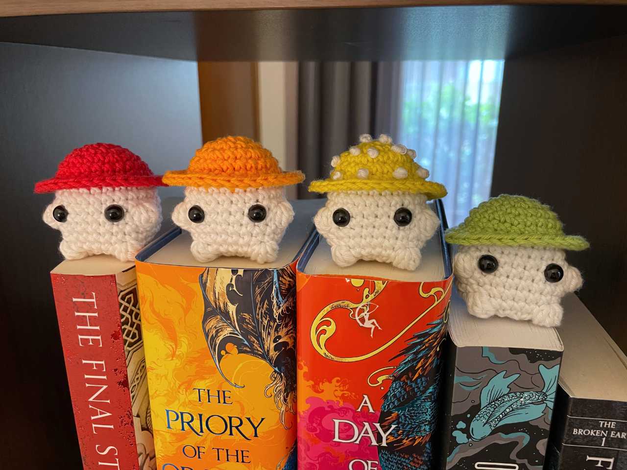 The first half of my mushroom amigurumi rainbow, on top of my book rainbow