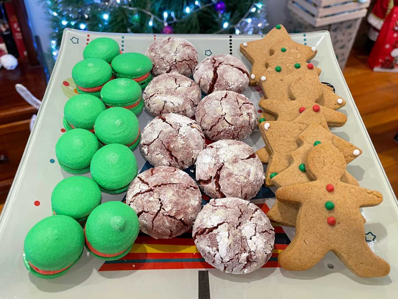 Variety of Christmas cookies; macarons, red velvet crinkle cookies and gingerbread